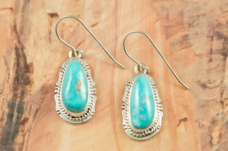 Genuine Castle Dome Turquoise set in Sterling Silver French Wire Earrings. Created by Navajo Artist Lucy Valencia. Signed LJ. The Castle Dome Turquoise Mine is located about 30 miles from the Sleeping Beauty Mine, near Globe, Arizona. The Castle Dome Mine has not been in operation since the early 1970s. 